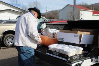 Mitchell County resident Tracy McIntyre loads his vehicle with barbecue before heading on his delivery route. (MNJ photo/Juliana Walker)