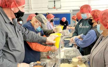 Volunteers from Spruce Pine Rotary, Higgins UMC and the community mix packets to be sealed, shipped and distributed to food-insecure people around the world. (MNJ photo/Laz Aguayo)