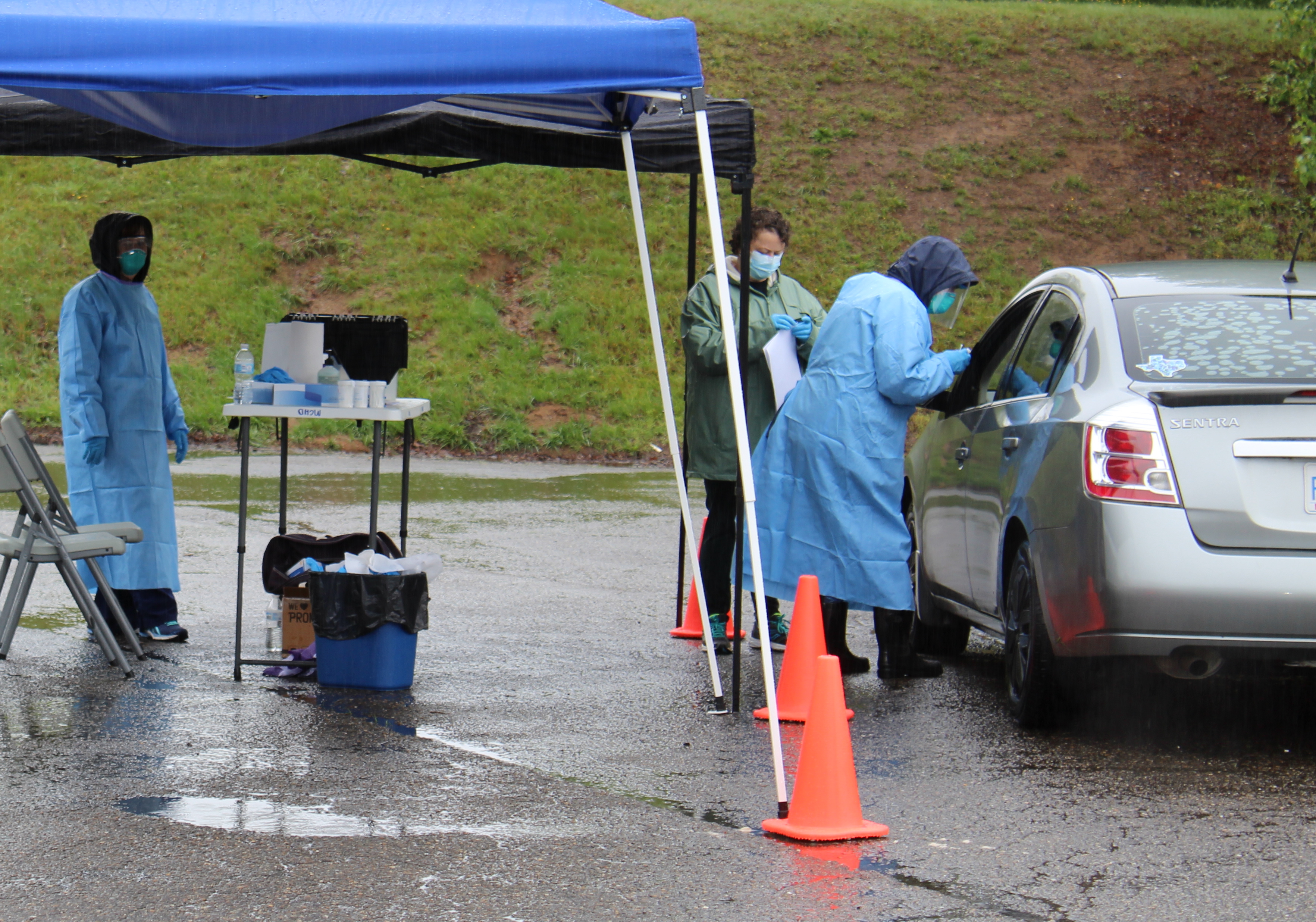 Mitchell County Health Department employees perform a COVID-19 test Thursday, May 21, at Harris Middle School. (Brandon Roberts/MNJ)