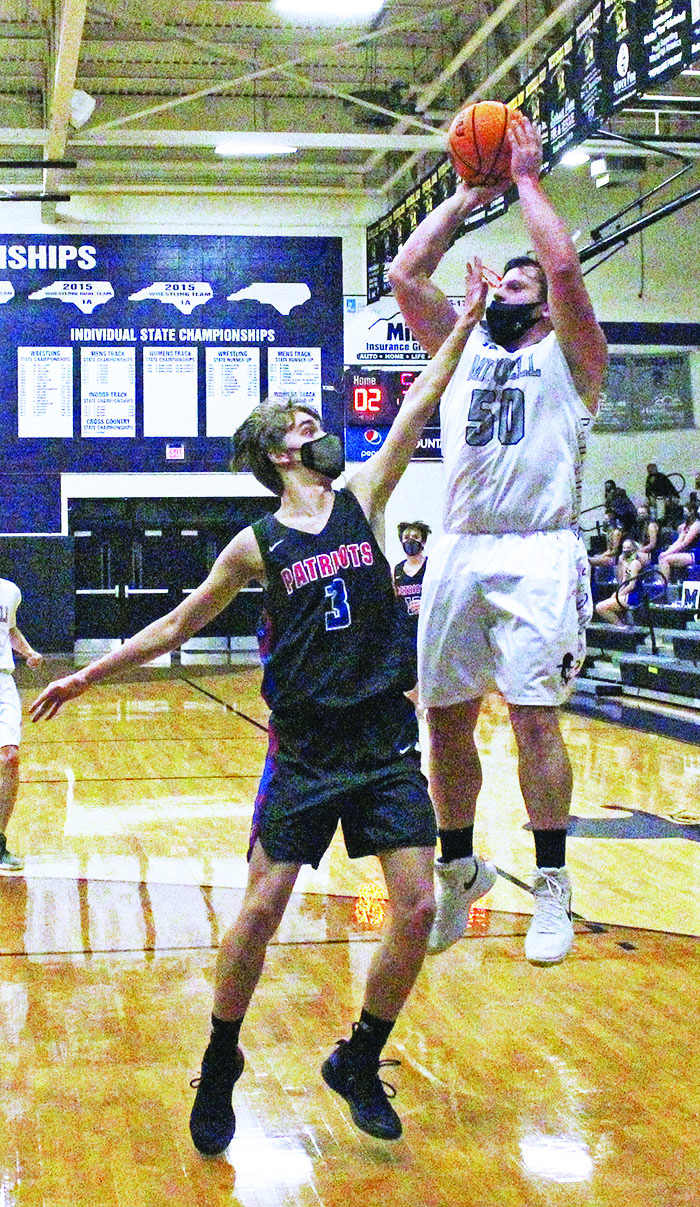 Mitchell’s Cole Sparks puts up a jump shot as he’s defended by Madison’s Ryan Waliezer on Thursday, Jan. 21. (MNJ photo/Cory Spiers)
