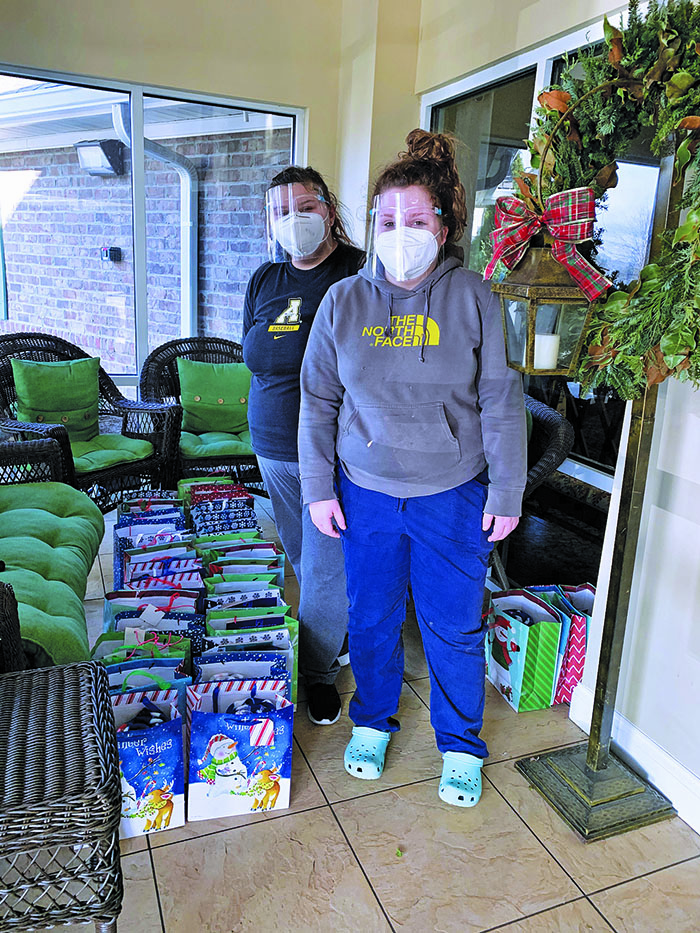 Volunteers Nalla Glen (left) and Abby Barker assist with gift sorting. (Submitted)