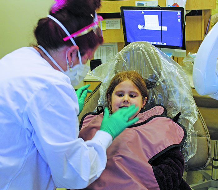 Elisabeth McKinney, a 4-year-old Bakersville resident, gets prepared for a dental X-ray on Friday, Feb. 5 during the annual Give Kids a Smile event at the East Carolina University School of Dental Medicine Community Service Learning Center in Spruce Pine. (MNJ photo/Cory Spiers)
