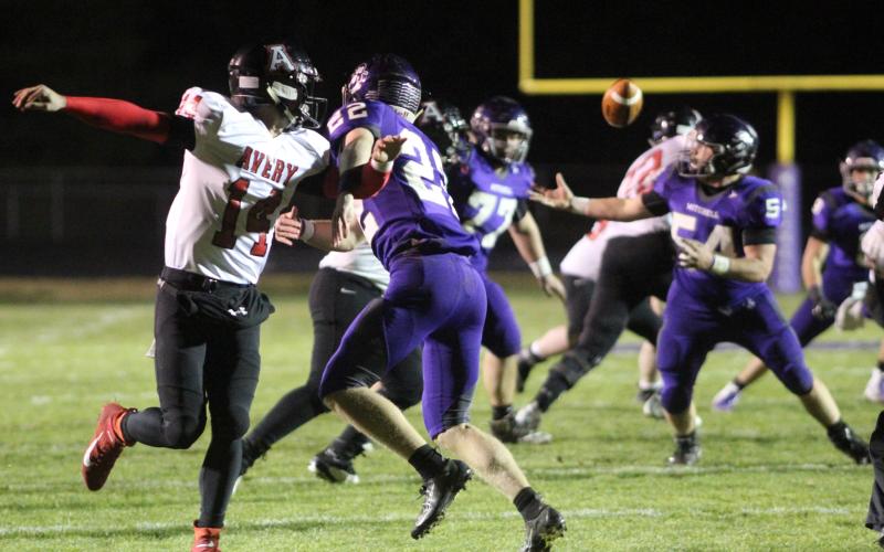 Mitchell sophomore Carter Hoyle (No. 22) causes Avery junior quarterback Troy Hoilman to throw an errant pass that was intercepted and returned for a touchdown by senior lineman Matthew Gilbert (No. 54). The Mountaineers ended the regular season with a 51-6 win over the Vikings Friday, Nov. 8, in Ledger. (Brandon Roberts/MNJ)