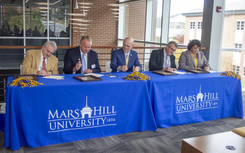The Local Lion Promise guarantees scholarships covering at least half the price of tuition for students from Buncombe, Madison, Mitchell and Yancey counties. Pictured, from left, are school superintendents Tony Baldwin, of Buncombe County, and Will Hoffman, of Madison County; Mars Hill University President Tony Floyd; and school superintendents Chad Calhoun, of Mitchell County, and Kathy Amos, of Yancey County. (Submitted)