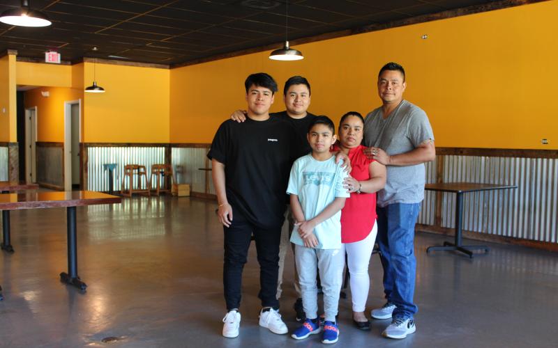 Claudia Pile and her three sons, left to right, Johnny, James and Joshua Pile, and husband Victor Hernandez in their new  restaurant space in the Spruce Pine Commons  Shopping Center. They hope to open the new location in two weeks. Photo by Juliana Walker/MNJ.