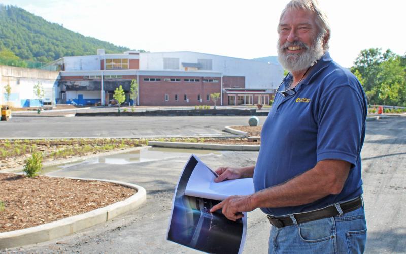 President of Mayland Community College John Boyd shows off architecture plans for the soon-to-be Three Peaks Enrichment Center. The old Pine Bridge complex and hotel are both under construction to become part of Mayland’s campus.