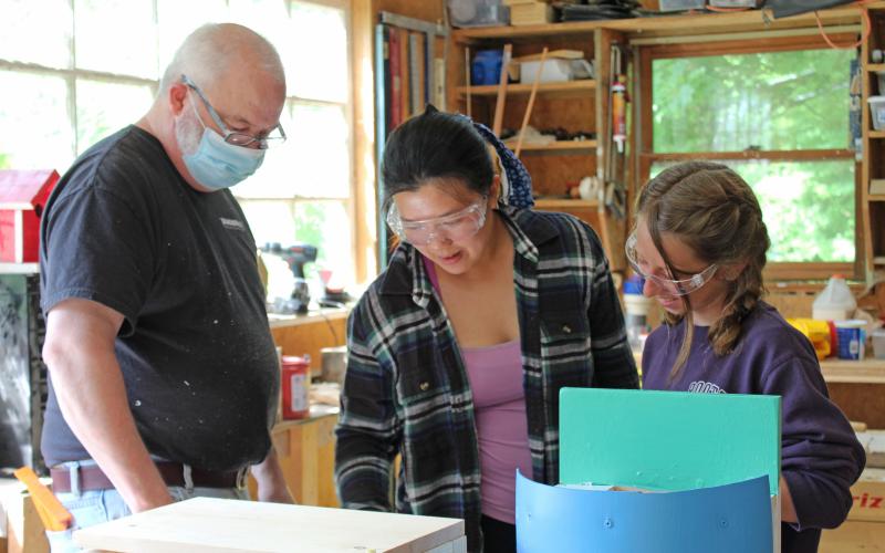 Mark Peters, Anna Zheng and Remi Koebel work on a project in wood working class at Camp Spring Creek in Bakersville. The camp has had to accommodate restrictions and guidelines regarding the ongoing coronavirus pandemic. (MNJ photo/Juliana Walker)