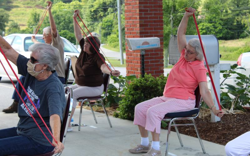 Class attendees stretch out their arms with exercise bands during an exercise class led by Mitchell County Director of Recreation Brock Duncan at the Senior Center. Pictured Left to Right: Mila Black, Jean Newton and Mattie Sparks. Photos by Juliana Walker/MNJ