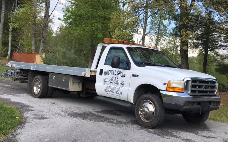 Two men were arrested this past week accused of stealing a rollback truck belonging to Mitchell County Commissioner Matthew “Vern” Grindstaff.