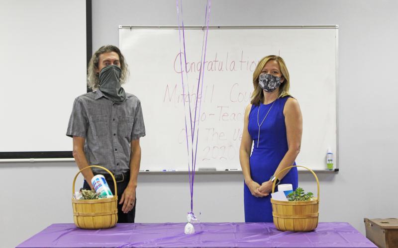 Co-teachers of the year Justin Hollifield and Michelle Lord stand masked and distanced while being recognized for their accomplishments Friday, Aug. 21 at the Mitchell County Schools Central Office. Hollifield will represent the county at the state level in January. (MNJ photo/Juliana Walker)