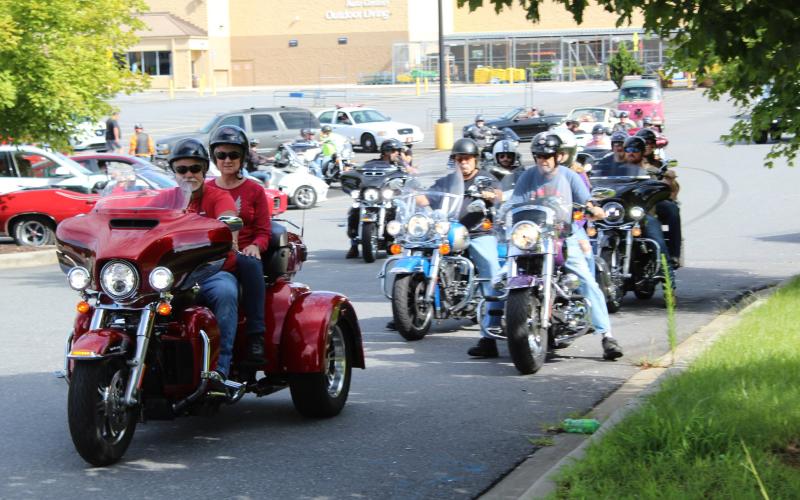 The first wave of vehicles that were part of the Maggie’s Ride convoy leaves the parking lot of the Spruce Pine Walmart Saturday, Aug. 22. Each vehicle in the convoy paid $20 to ride and all proceeds went to the Maggie Young Memorial Scholarship fund. The event raised nearly $2,000. (MNJ photo/Cory Spiers)