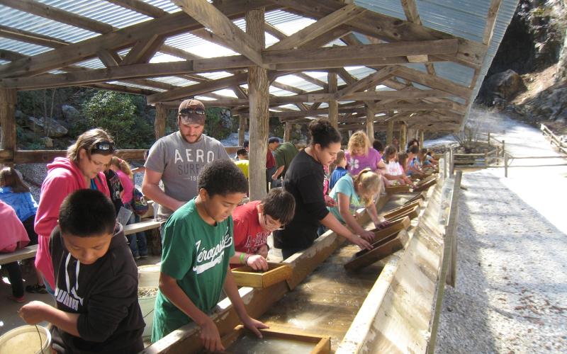 Visitors at Emerald Village of Little Switzerland pan for gold. The local mining tourist attraction was recently named a recipient of TripAdvisor’s 2020 Traveler’s Choice Award. Owner Alan Schabilion said the award is an honor and proves that the people coming to the attraction are making lasting memories while they’re there. (Submitted photo)