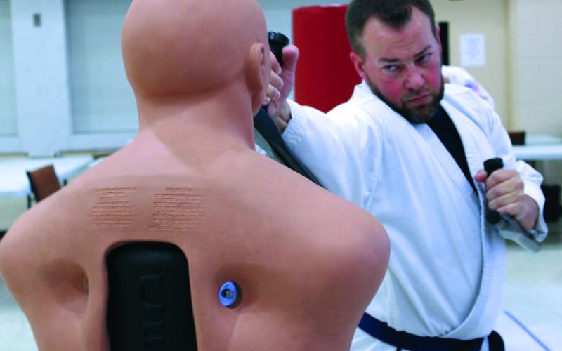 Local martial artist Brett Cloer practices delivering blows on a dummy during a recent martial arts class at Spruce Pine First Baptist Church. Cloer is one of dozens of students of all ages and experience levels who attend the classes twice per week to hone their skills. Classes are taught by Rocky Branch. (MNJ photo/Cory Spiers)