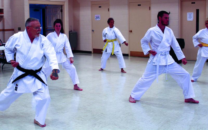 Martial artist David Lucas (left) leads a trio of fellow students during a group phase of a martial arts class at Spruce Pine First Baptist Church. Classes are open to all experience levels. (MNJ photo/Cory Spiers)