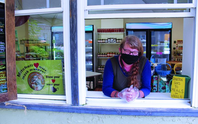Just Local Market Owner Megan Bell stands in her store’s pickup window ready to help customers. Bell is taking all the necessary precautions during the pandemic including always wearing gloves and a mask when interacting with customers and products. In addition, the pickup window is the only method of shopping available during the pandemic. Bell’s market sells products from local farmers. (MNJ photo/Cory Spiers)