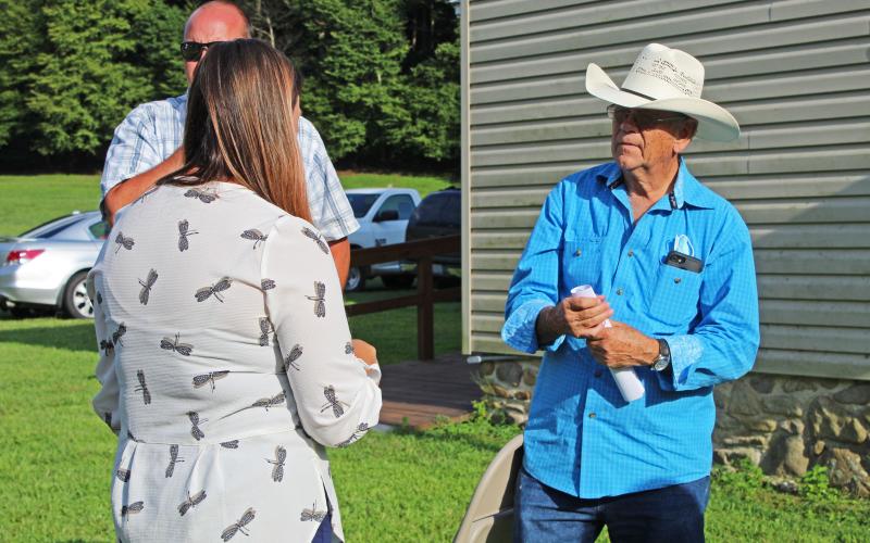 Halley Burleson speaks with a local Poplar resident before special meeting Tuesday, Aug. 25. (MNJ Photo/Juliana Walker)