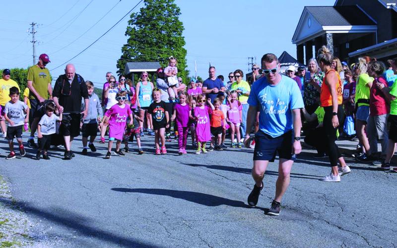 Run for Holland Organizer Adam Burleson takes off and leads the children’s portion of the annual Run for Holland charity race in this file photo from 2019. The annual event was originally delayed until Sept. 19 and has now moved into a virtual format due to the ongoing pandemic. Runners will complete their treks on their own time and submit their times online. The event will still benefit the local special needs community and participants can still win prizes. (MNJ file photo)