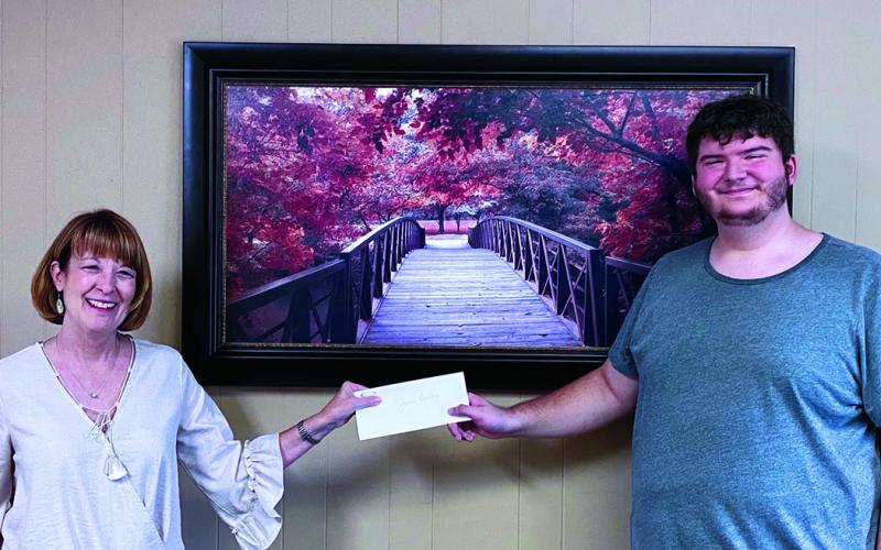 State Employees Association of North Carolina Scholarship Committee Member Rhonda Robinson presents James Biddix with his scholarship check. Biddix, a Mitchell High School graduate, was awarded $2,000-worth of scholarships from SEANC. (Submitted photo)