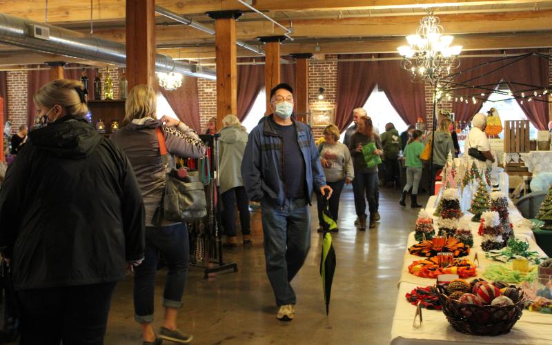 Spruce Pine Fall Festival attendees browse the wares available from some of the more than 40 vendors. (MNJ photo/Juliana Walker)