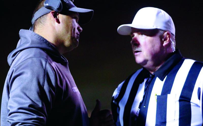 Mitchell High School head varsity football coach Travise Pitman talks things over with an official during a 2019 state playoff game. Pitman and his team will return to play in February. (MNJ file photo)