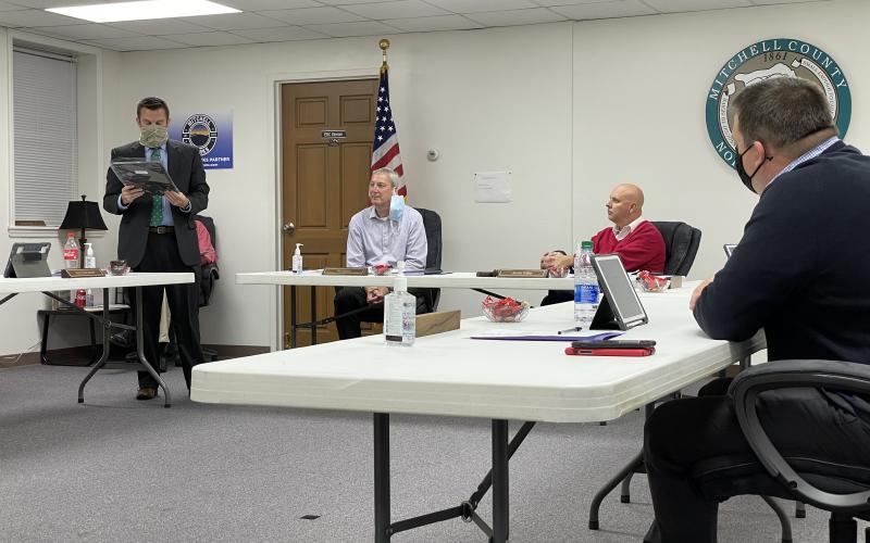Commissioner Matthew “Vern” Grindstaff (left) reads off the text inscribed on plaques that were presented to Jacob Willis and Danny Burleson, who will both leave the board. Willis and Burleson each gave short addresses regarding their time on the board. (MNJ photo/Juliana Walker)