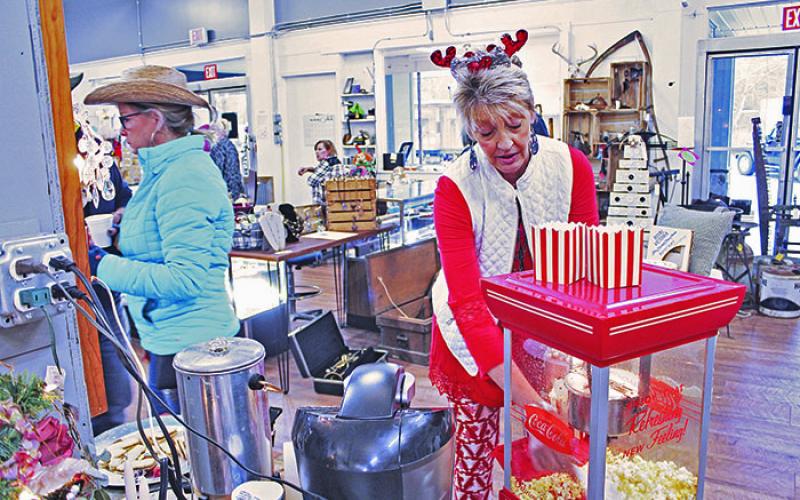 Treasures in the Pines co-owner Cheryl Buchanan prepares popcorn during last year’s Small Business Saturday in downtown Spruce Pine. This year’s event will take place completely virtually. (MNJ file photo)