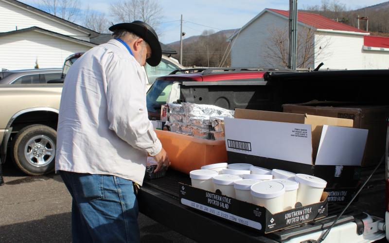 Mitchell County resident Tracy McIntyre loads his vehicle with barbecue before heading on his delivery route. (MNJ photo/Juliana Walker)
