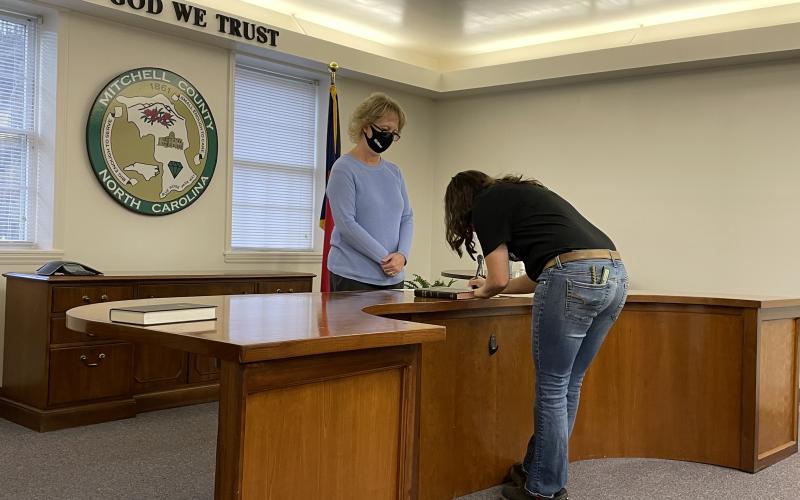Newly-elected Mitchell County Commissioner Harley Masters is sworn in by Mitchell County Register of Deeds Kathy Laws on Monday, Dec. 7. The new board approved changes at its first meeting. (MNJ photos/Juliana Walker)
