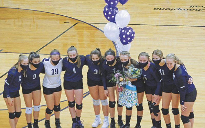 The Mitchell High School varsity volleyball team poses with its lone senior, Erika Gouge, before the start of its game against Mountain Heritage. (MNJ photo/Cory Spiers)