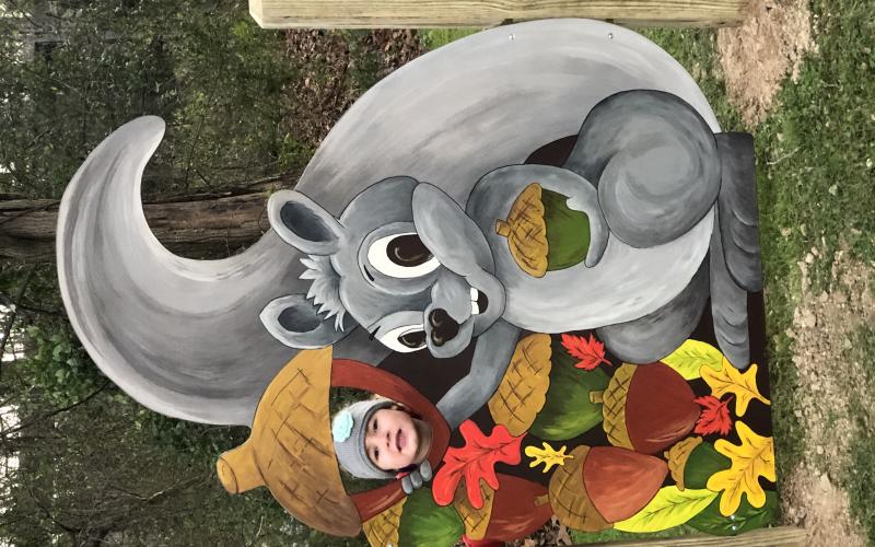 Piney the Squirrel, the mascot for the new Riverside Park story trail tale, greets visitors with a smile and a prime photo opportunity. Piney was created by Penland School of Craft artist Day Dotson. The story trail is a parnership between AMY Regional Library, Blue Ridge Partnership for Children, Penland School of Craft, Williams YMCA of Avery County and the Town of Spruce Pine. (Submitted photo)