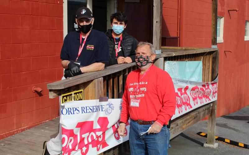 (Left to right): Mark Thomas, Coleman Taylor and Bert Nunley take a break from their distribution duties on Saturday, Dec. 12 to pose for a photo outside of the Toys for Tots office. (MNJ photo/Juliana Walker)