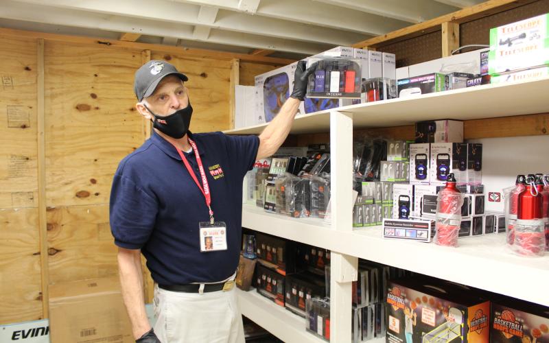 Toys for Tots Coordinating Officer Mark Thomas shows off some of the many items the organization has on hand to provide to children in need this Christmas. On Saturday, Dec. 12, Thomas and several other volunteers sorted, packaged and distributed toys for more than 300 area children. (MNJ photo/Juliana Walker)