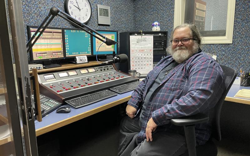 Bruce Ikard, who has served as the primary announcer for WTOE for the majority of the past four decades, sits in the WTOE control room during a normal day in the office. WTOE recently added an FM station in an effort to expand its coverage to more people in the region.  (MNJ photo/Juliana Walker)