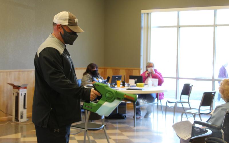 Recreation Director Brock Duncan volunteered his time on Thursday to help sanitize seats and equipment with his special sanitizing gun. “I have to use this sanitizing gun at all of the Rec games anyway, so I figured I’d put it to good use here too,” he said. (MNJ Photo/Juliana Walker)