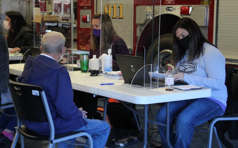 Health Promotion Supervisor Jessica Farley registers a local resident’s information into the state system, CVMS, which stands for “COVID-19 Vaccine Management System.” The system helps with track the vaccine rollout across the state. (MNJ Photo/Juliana Walker)