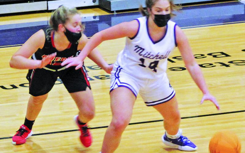 Junior guard Chloe Carter works her way around an Avery defender on Friday, Jan. 29. Carter scored five points and added two assists as she helped the Mountaineers rout Avery 65-33. Mitchell moved to 8-0 on the season with the win over the Vikings. (MNJ photo/Cory Spiers)