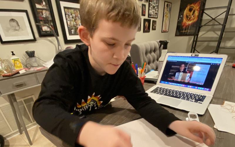 Ben Deyton, a student in Michelle Lord’s third-grade class at Gouge Elementary, gets to work creating his moon journal. The moon journal project, which has been part of the county’s third grade curriculum for two decades, went virtual for the first time this year due to the ongoing pandemic. (Submitted photo)