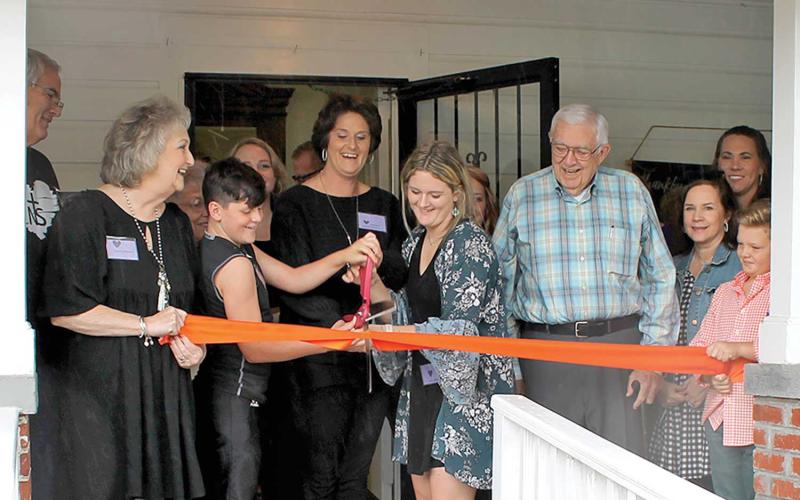 Jessica Williams (center) joined by family and friends cuts the ribbon marking the opening of Hope House, a residential Christian Restoration &amp; Transformation Program for women recovering from drug addiction. (MNJ photos/ Rachel Hoskins)