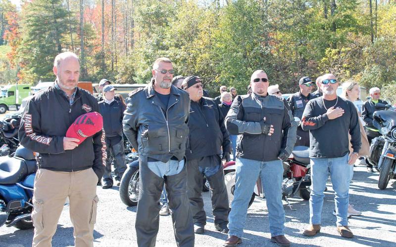 MNJ photo/Rachel Hoskins - Riders take a moment to salute the flag during the singing of the National Anthem.