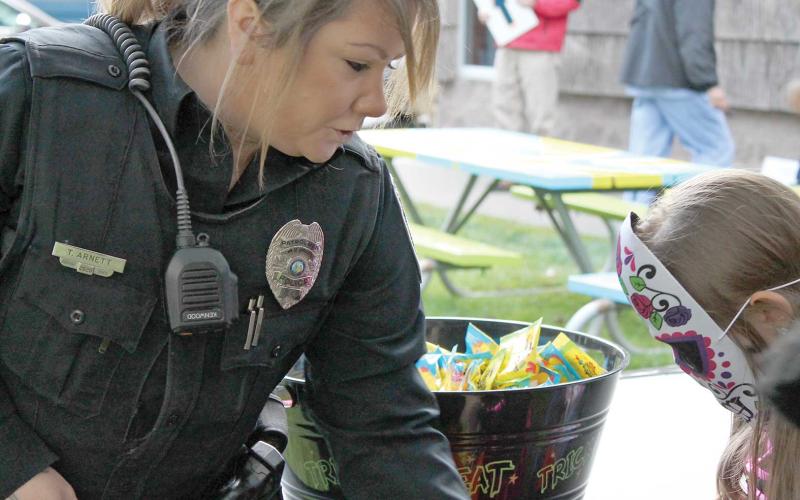 Office Tara Arnett with the Spruce Pine Police Department handed out candy to hundreds of trick-or-treaters on Saturday night. While some kids were dog-gone-tired, others enjoyed the candy shoot at DT’s Blue Ridge Java. Parents and kids alike enjoyed the evening in Spruce Pine and Bakersville. (MNJ Photos/Rachel Hoskins)