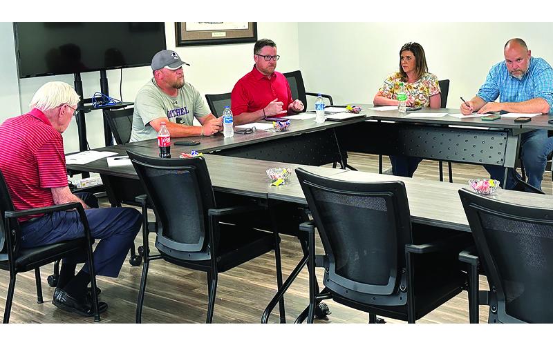 Photo/Mitchell County Government. Mitchell County officials, Lloyd Hise, Brock Duncan, Stan Cook, Christy Young and Allen Cook review bids for construction of the new recreation center.