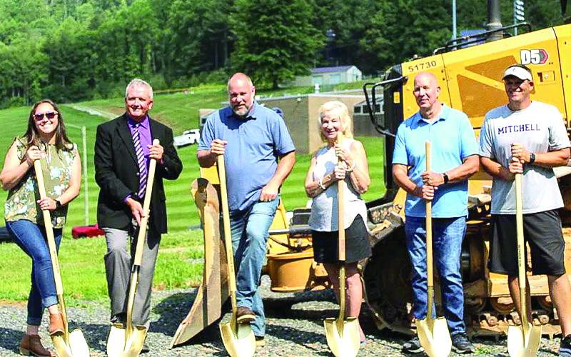 MNJ Photo/Sarah Atkins. From left, County Commissioner Harley Masters, Mitchell County Schools Superintendent Chad Calhoun, County Manager Allen Cook, school board member Brenda Sparks, county commissioner candidate Dale Blevins and Mitchell High School Athletic Director Travise Pittman break ground on a new athletic center.