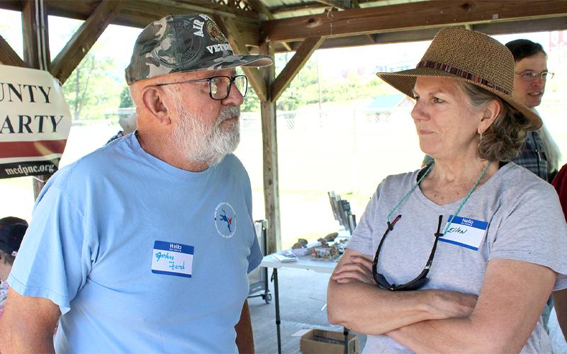 MNJ photo/Mariel Williams. N.C. House of Representatives candidate John Ford, left, chats with Mitchell voter Ellen Miller at the Mitchell County Democratic Party’s ice cream social at Riverside Park.