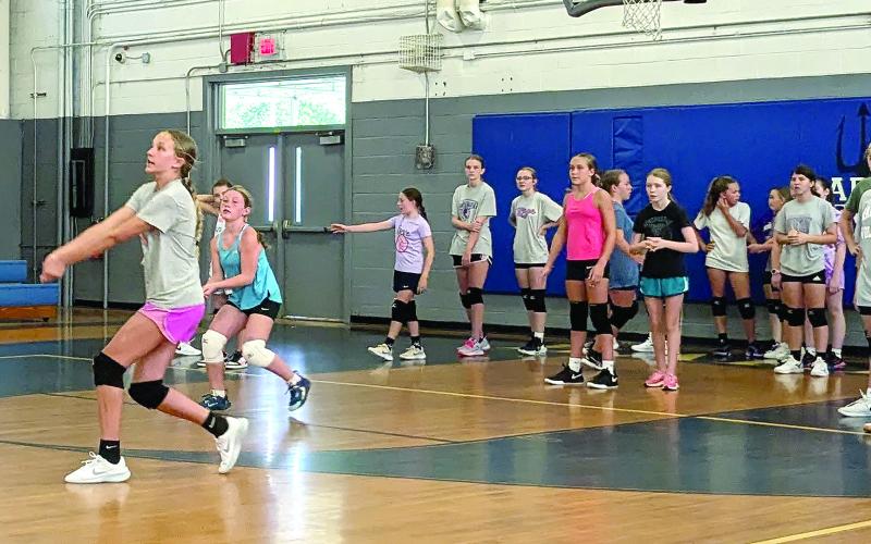 MNJ photos/Brian Hobson. Mitchell Middle School recently held volleyball tryouts. Here, a group of three girls attempt to pass the ball twice before putting it back over the net.