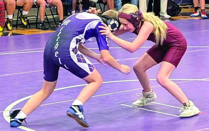 Submitted photo. Brookelynn Helmer tackles a Swain opponent in middle school girls wrestling action.