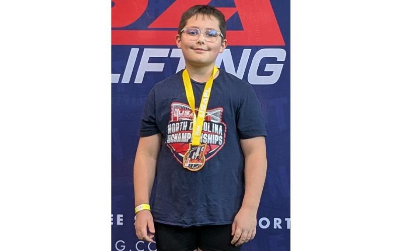 MNJ Photo/Brian Hobson.  Connor Hobson poses with his medal after the championship. Hobson set a new National record with a 43kg bench press.