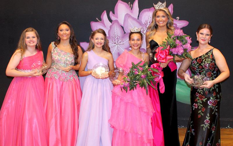 Submitted photo.  The new 2026 NC Rhododendron Queen Kaylyn Fairchild and Junior Queen Kimber Ostrander were crowned Saturday. From left are Scout Stevenson (congeniality), GraceLynn Lovick (second runner up), Eliza Bray (first runner up, evening gown, talent) Kimber (junior queen and interview), Kaylyn (queen, and also winning interview and swimsuit), and Gracyn Strickland (first runner up, talent and congenitally winner).