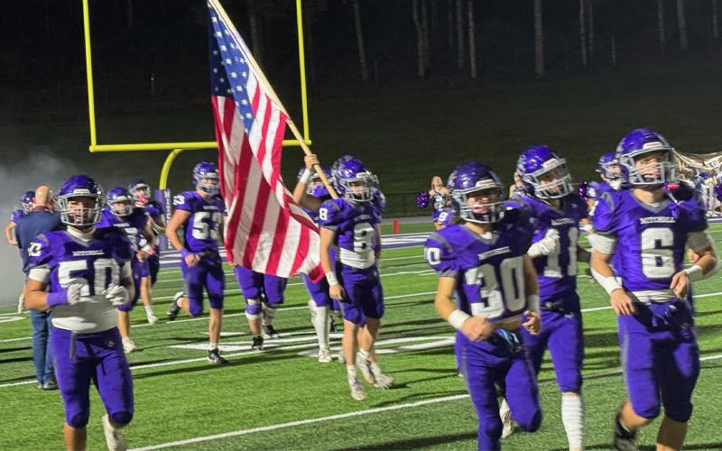 Photo/Laz Aguayo. The Mitchell High School Mountaineers were all smiles as they ran onto the field for Homecoming.