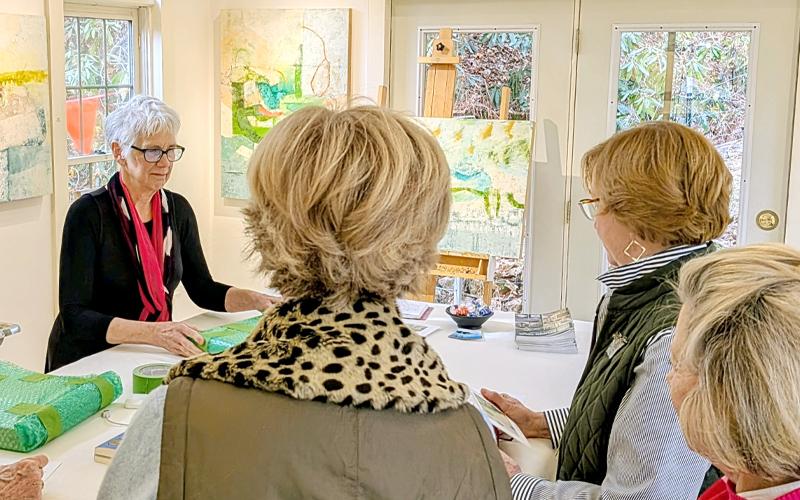 MNJ Photo/Steffen Silvis. Painter Carmen Grier, left, chats with three Charlotte art collectors while wrapping their purchases. The biannual Studio Tours bring in a number of art fans from outside the area.