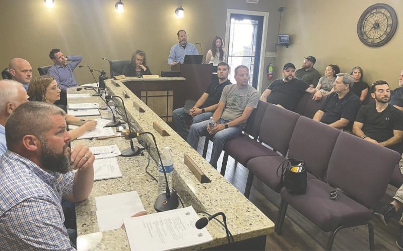 MNJ Photo/Mariel Williams. Jon Blasco and Kayleigh Gill give a presentation to the Spruce Pine Town Council on behalf of engineering firm WithersRavenel. The presentation on revitalizing the downtown streetscape attracted a bigger crowd than usual to the meeting.